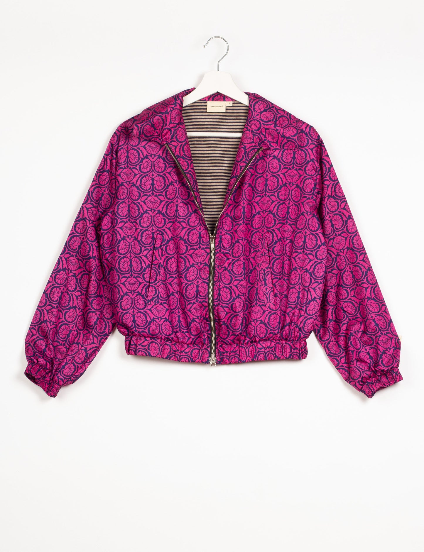 Stylish BOMBER JACKET, an upcycled clothing masterpiece with a cute cropped shape, elasticated details, and detachable metallic zipper. Contrast sari print lining adds a unique touch. Explore sustainable and eco-friendly fashion.