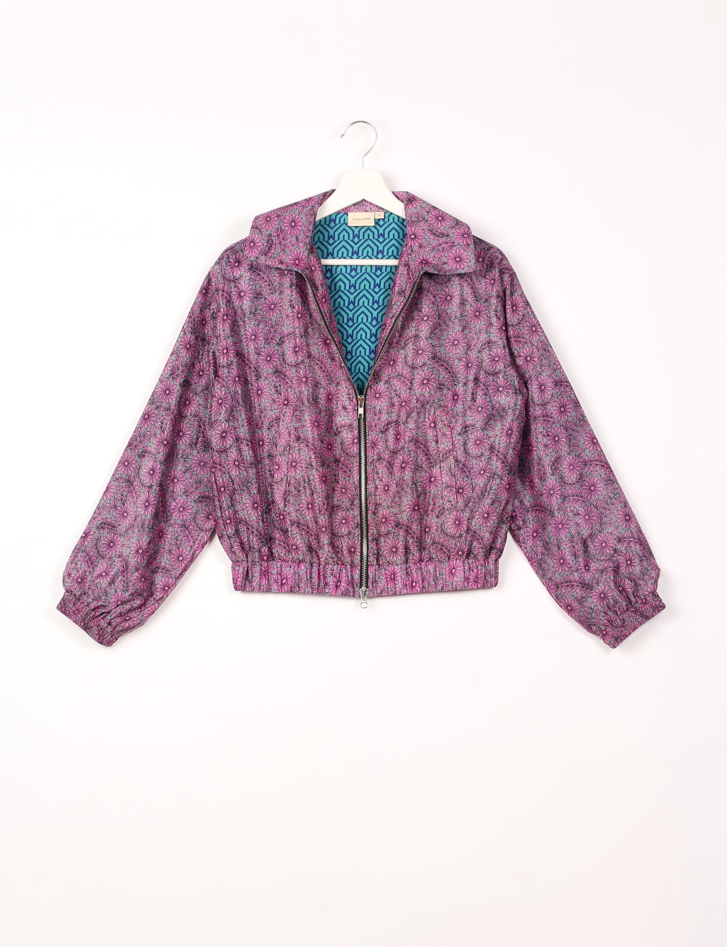 Stylish BOMBER JACKET, an upcycled clothing masterpiece with a cute cropped shape, elasticated details, and detachable metallic zipper. Contrast sari print lining adds a unique touch. Explore sustainable and eco-friendly fashion.