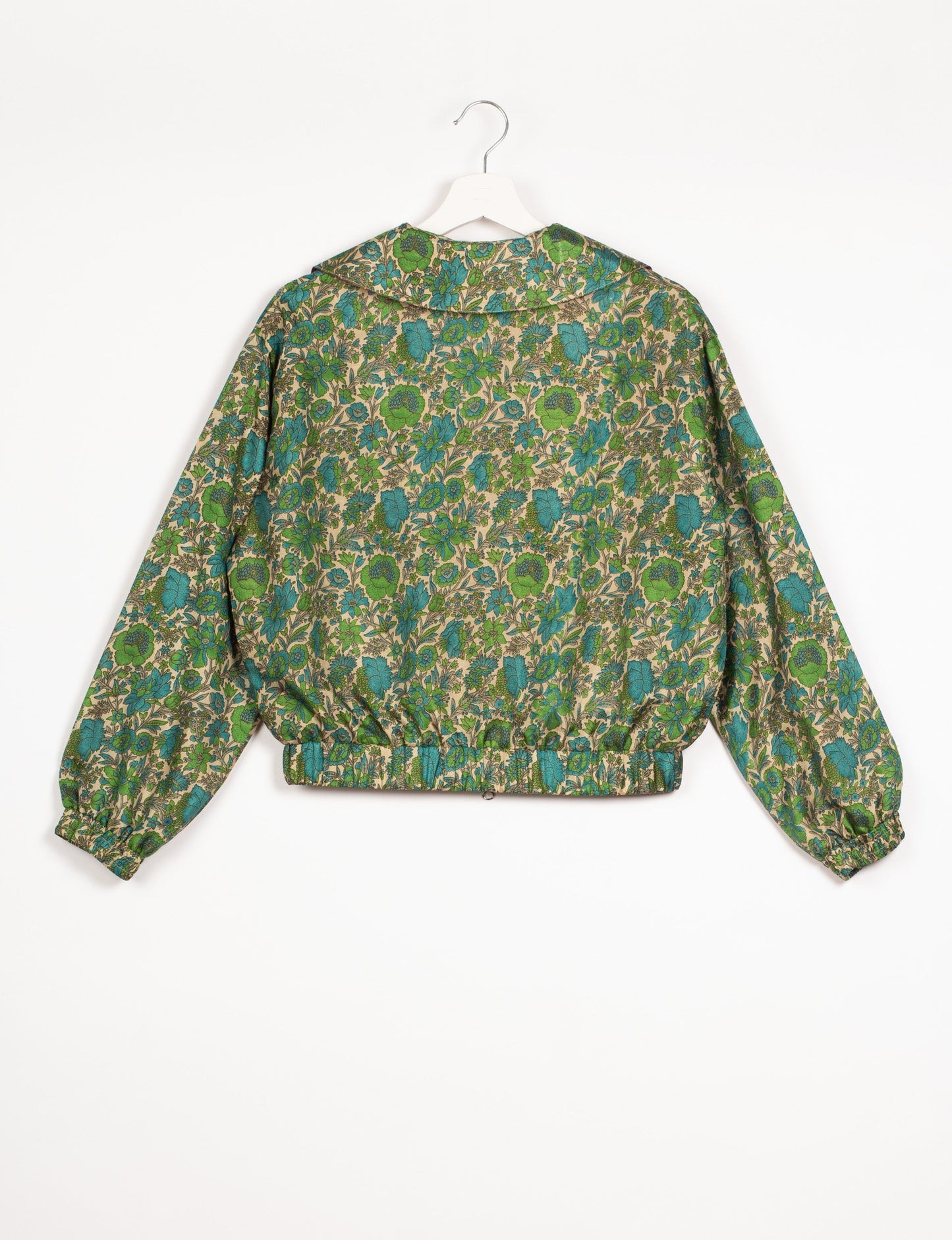 Stylish BOMBER JACKET, an upcycled clothing masterpiece with a cute cropped shape, elasticated details, and detachable metallic zipper. Contrast sari print lining adds a unique touch. Explore sustainable and eco-friendly fashion.