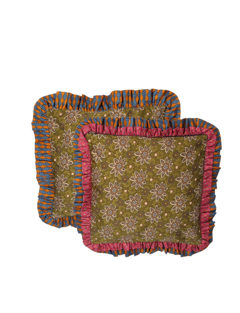 Set of two green floral cushion covers with double frill edges in orange-blue and pink-blue patterns, flat lay view