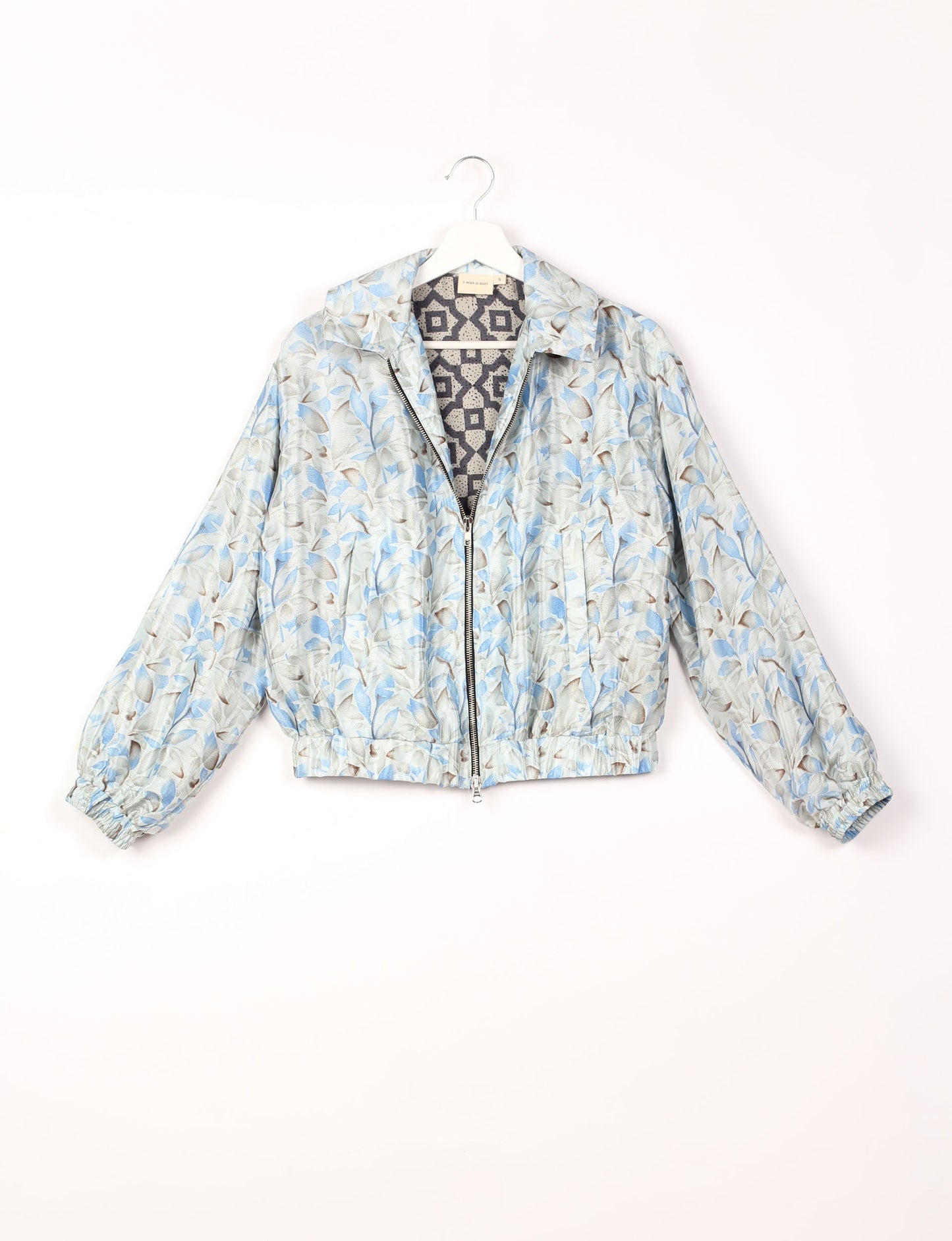 Stylish BOMBER JACKET, an upcycled clothing masterpiece with a cute cropped shape, elasticated details, and detachable metallic zipper. Contrast sari print lining adds a unique touch. Explore sustainable and eco-friendly fashion.