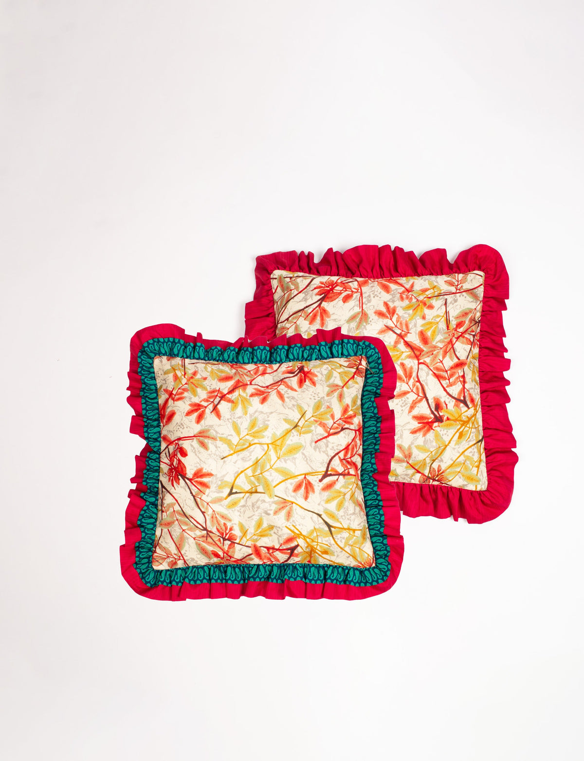 Set of 2 beige cushion covers with tropical leaf print, double frill edges in red and green, flat lay view
