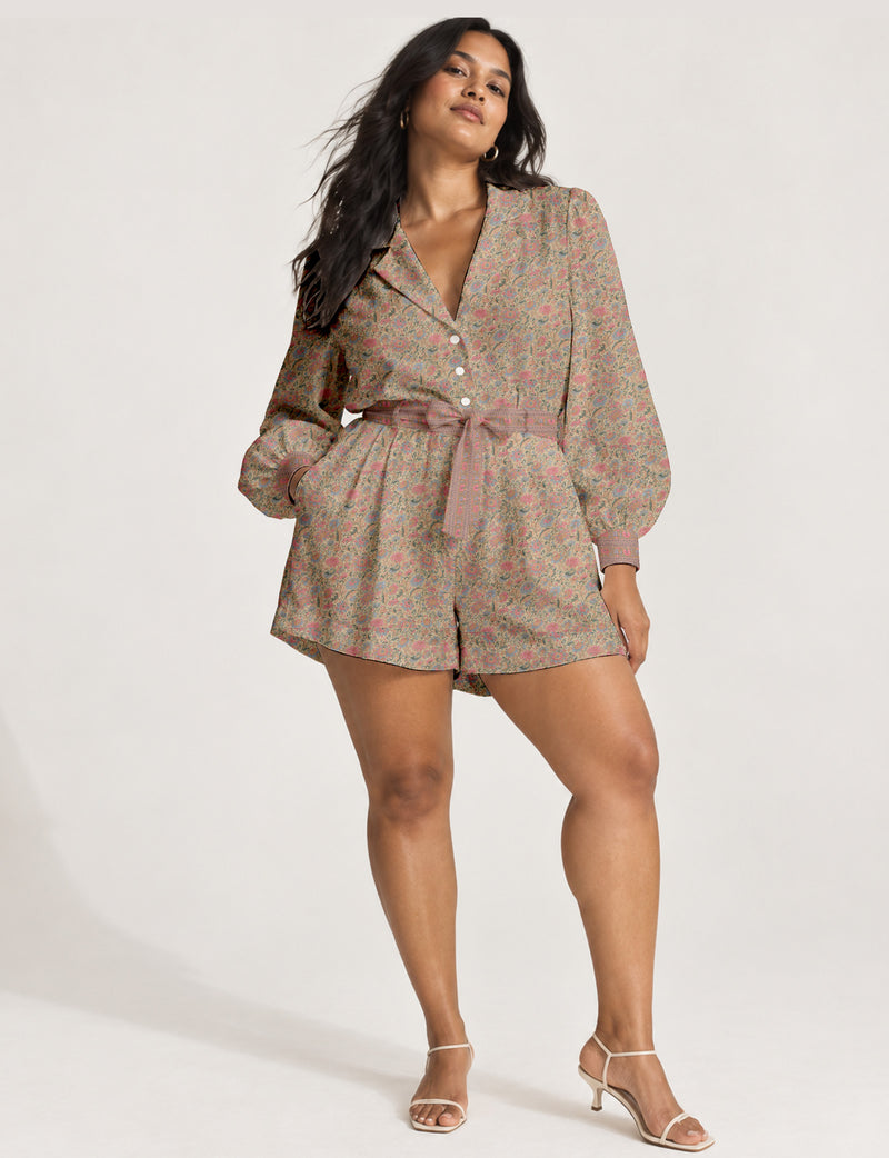 Women’s long sleeve playsuit with wrap-style front, V neckline, notched collar, adjustable waist tie and mid-thigh shorts.