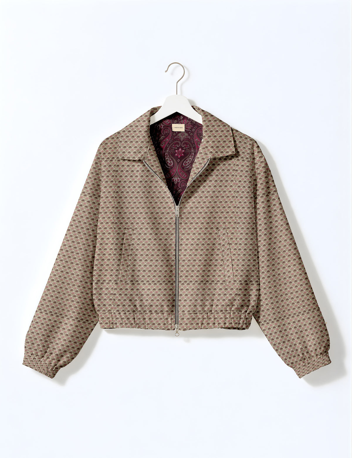 Brown floral bomber jacket with front zipper, elastic cuffs and hem, hanging on white hanger, red floral inner lining visible
