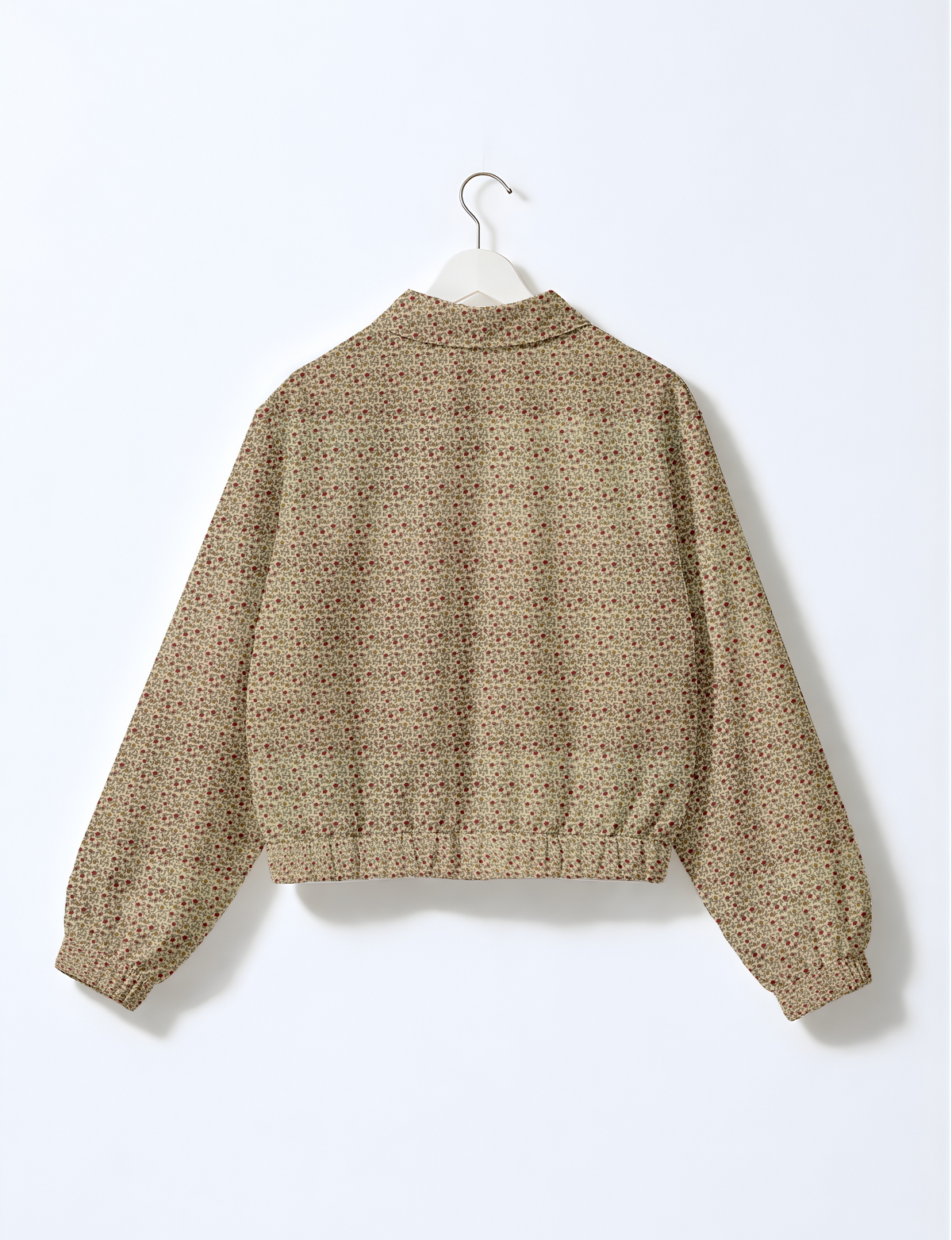 Beige floral bomber jacket with elastic cuffs and waistband, shown from back on white hanger against white background