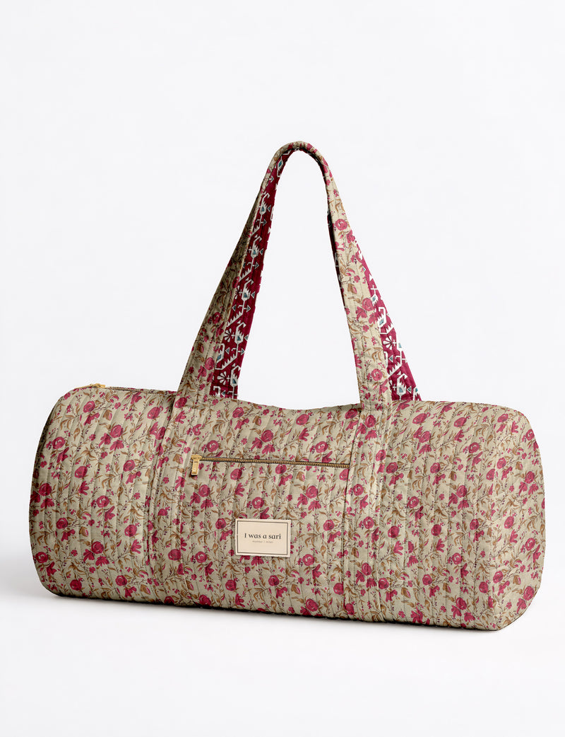 Brown paisley quilted bowling bag with dual handles, front zipper pocket, and "I was a sari" label on front side