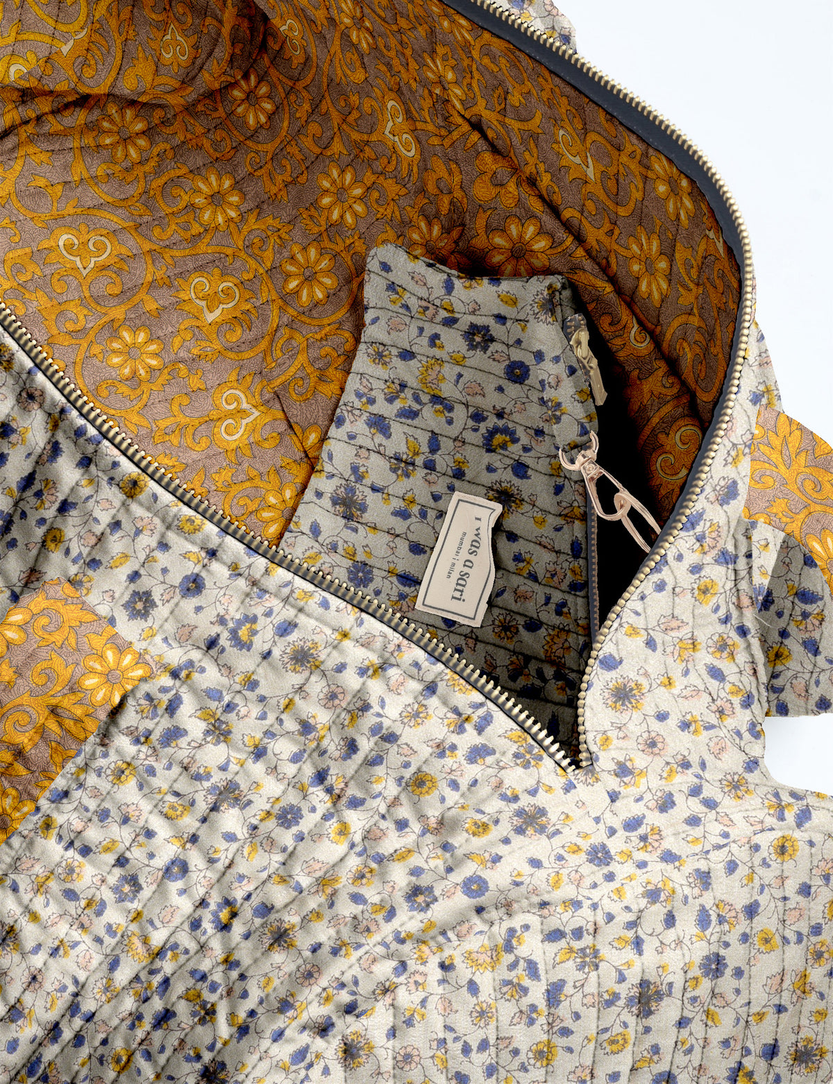 Brown paisley quilted bowling bag with dual handles, front zipper pocket, and "I was a sari" label on front side