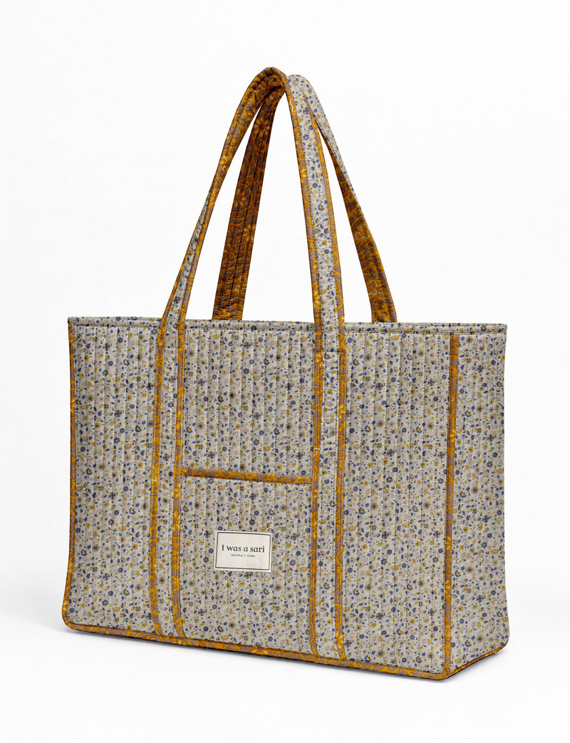 Quilted work tote bag with structured rectangular design and long shoulder straps, representing slow fashion and ethical clothing ideals, made as part of upcycled women's clothing and sustainable women's clothing using recycled fashion and earth friendly clothing practices.