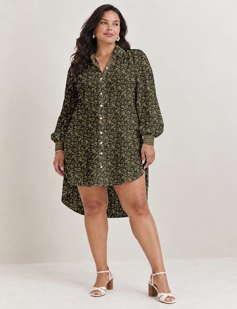 High low shirt with a relaxed fit, button-down front, classic collar, gathered shoulders and full-length blouson sleeves.