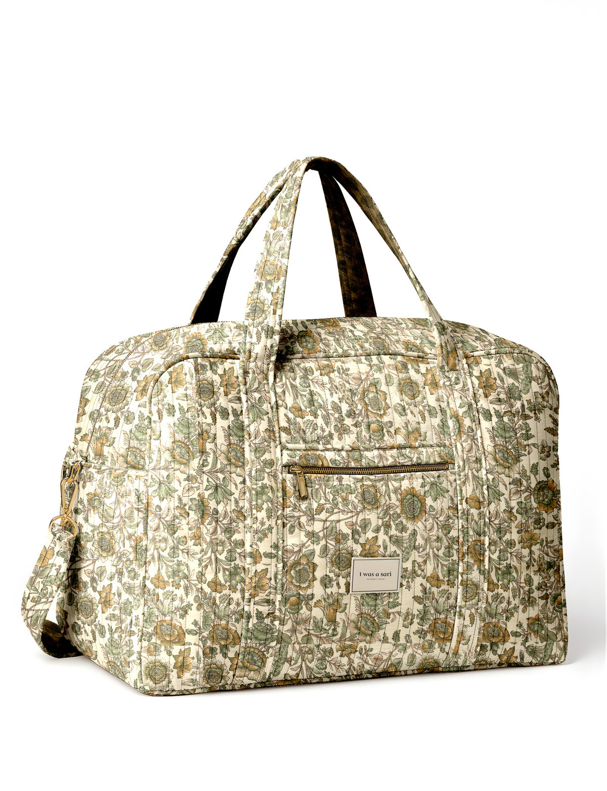 Brown quilted duffle bag with paisley pattern, front zip pocket, dual handles, and label reading "I was a sari"