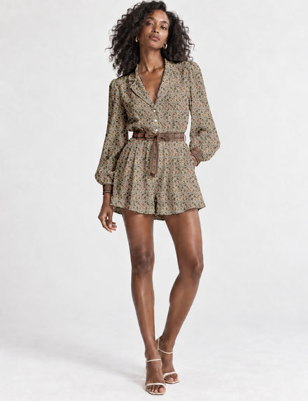 Women’s long sleeve playsuit with wrap-style front, V neckline, notched collar, adjustable waist tie and mid-thigh shorts.