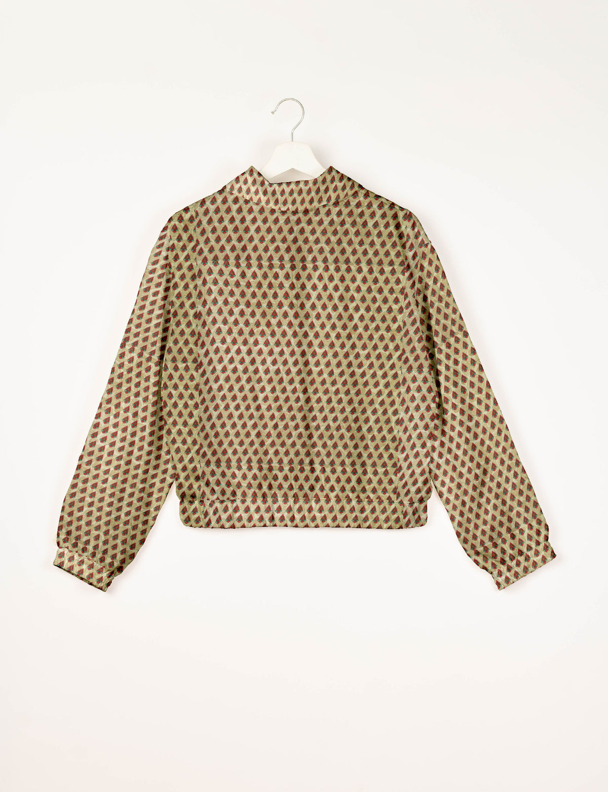 Beige bomber jacket with red and green Indian ethnic print, long sleeves, elastic cuffs and waistband, back view on hanger