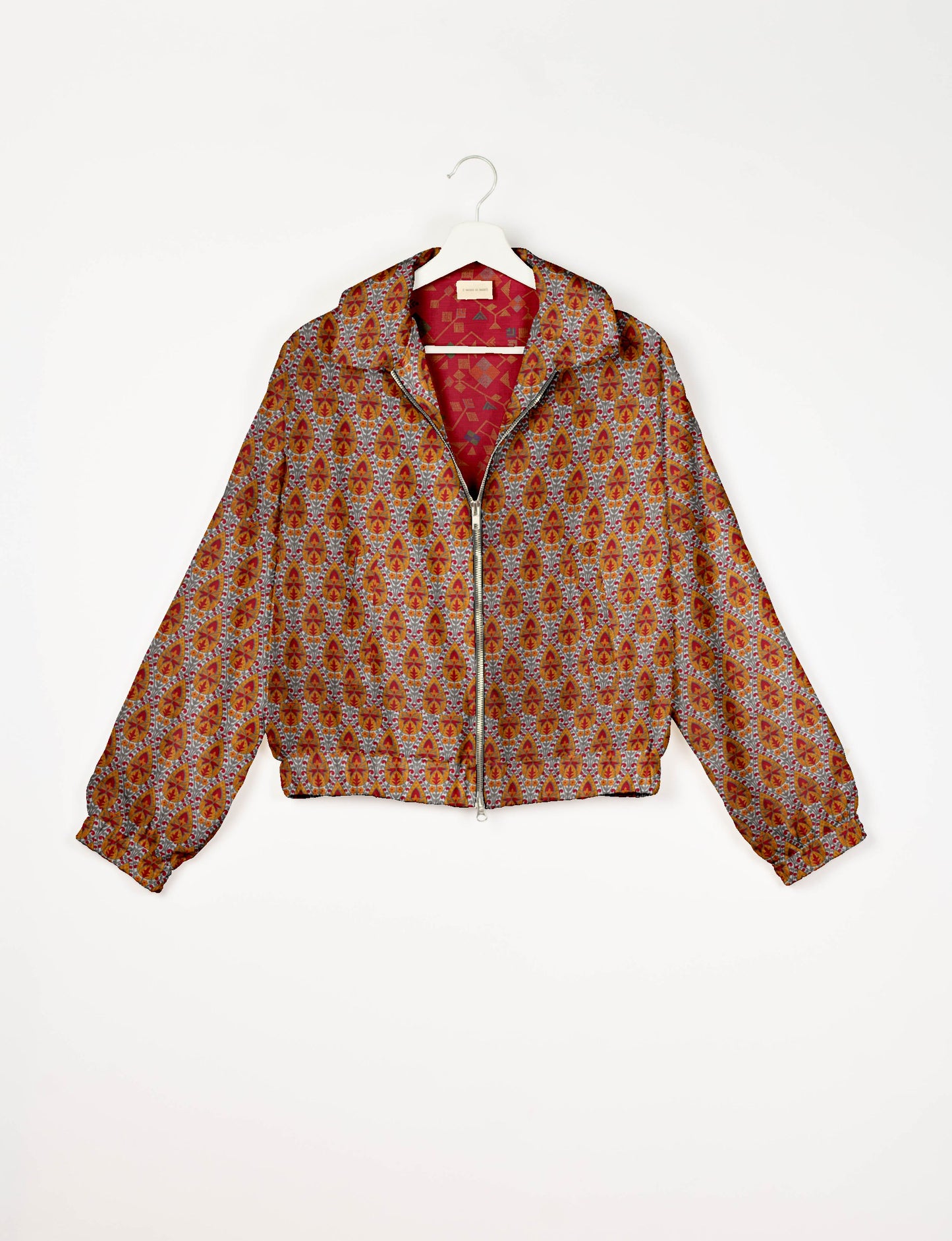 Upcycled Bomber Jacket made from recycled sari materials, featuring a cute cropped shape, elasticated hem and cuffs, and contrast sari print lining. Sustainable apparel promoting eco-friendly fashion and ethical clothing.
