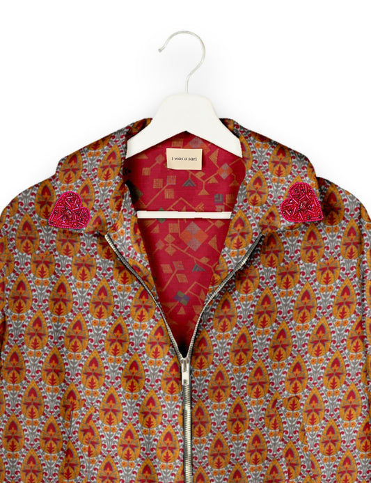 Make a bold statement with our Heart Drop Earrings, a symbol of conscious luxury and ethical fashion. Handcrafted using the intricate Aari embroidery technique, these earrings are made from upcycled sari fabric, embracing slow fashion and zero waste clothing. Elevate your look with sustainable apparel that supports fair trade fashion while reducing textile waste. Choose eco-friendly fashion that speaks of love, artistry, and responsibility.