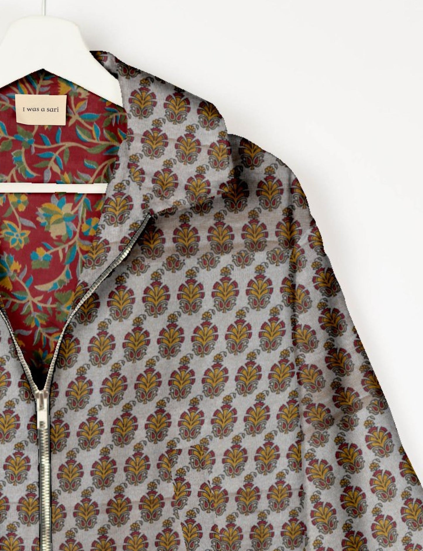 Upcycled Bomber Jacket made from recycled sari materials, featuring a cute cropped shape, elasticated hem and cuffs, and contrast sari print lining. Sustainable apparel promoting eco-friendly fashion and ethical clothing.