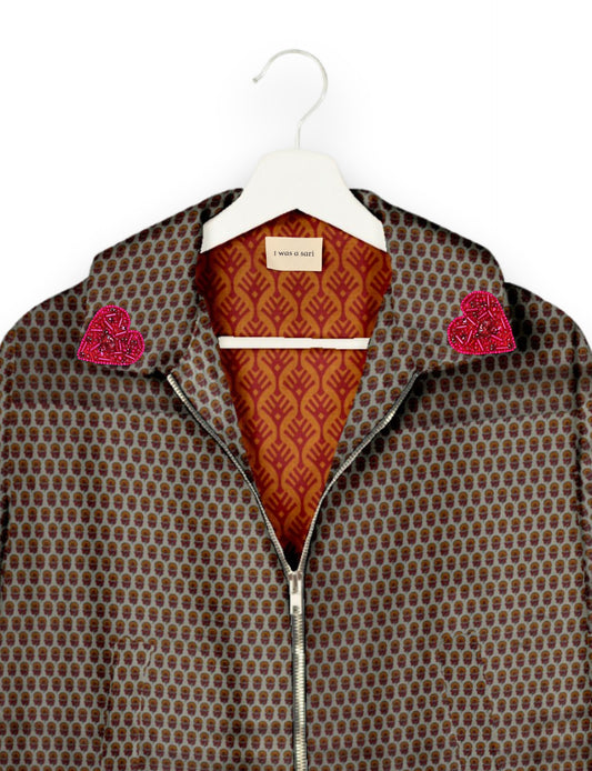 Make a bold statement with our Heart Drop Earrings, a symbol of conscious luxury and ethical fashion. Handcrafted using the intricate Aari embroidery technique, these earrings are made from upcycled sari fabric, embracing slow fashion and zero waste clothing. Elevate your look with sustainable apparel that supports fair trade fashion while reducing textile waste. Choose eco-friendly fashion that speaks of love, artistry, and responsibility.