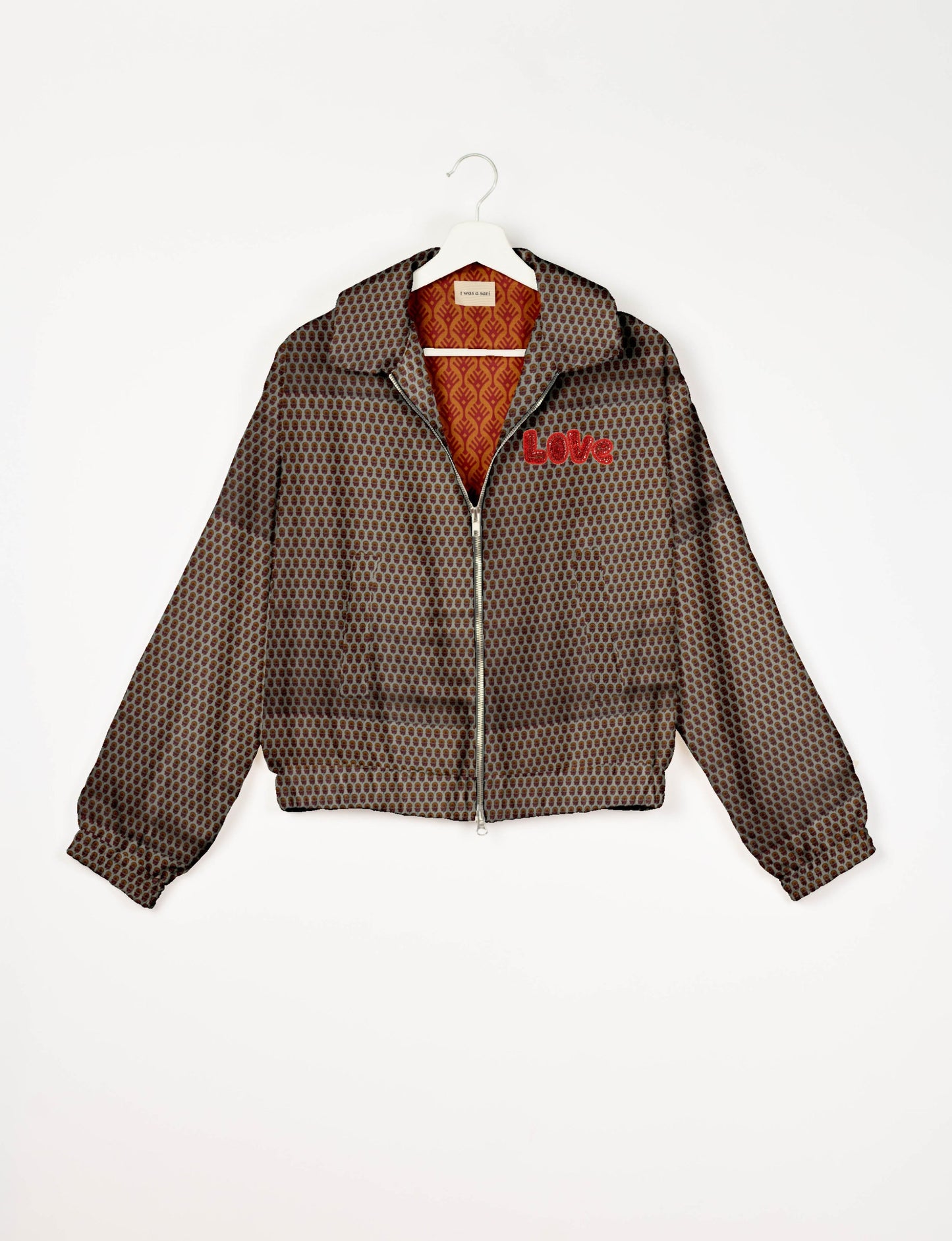 Love Bomber Jacket made from recycled fabric, featuring hand-stitched Aari embroidery. A unique piece of zero-waste clothing, part of the circular fashion movement. Designed with upcycled materials for a stylish yet environmentally friendly clothing choice.