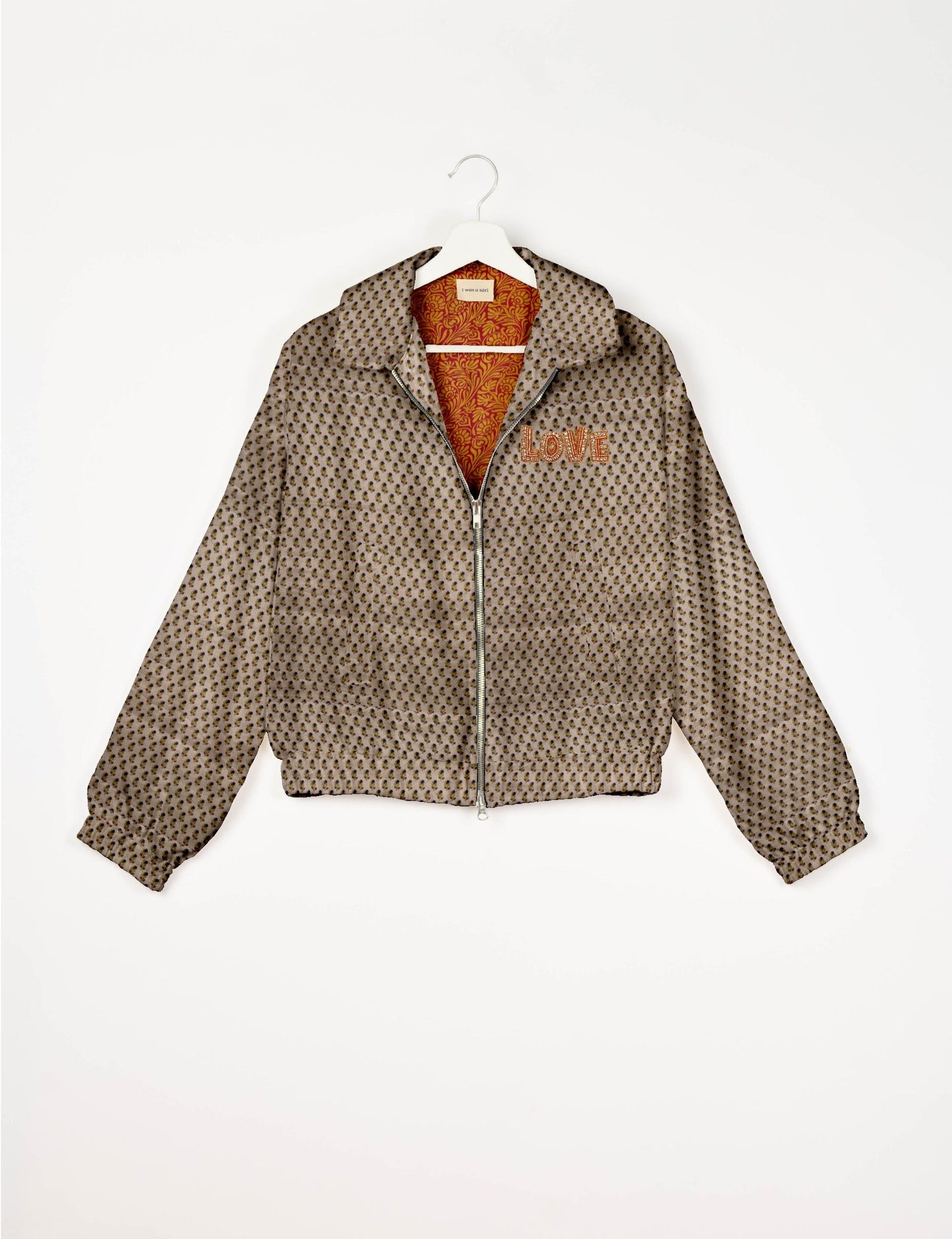 Love Bomber Jacket made from recycled fabric, featuring hand-stitched Aari embroidery. A unique piece of zero-waste clothing, part of the circular fashion movement. Designed with upcycled materials for a stylish yet environmentally friendly clothing choice.