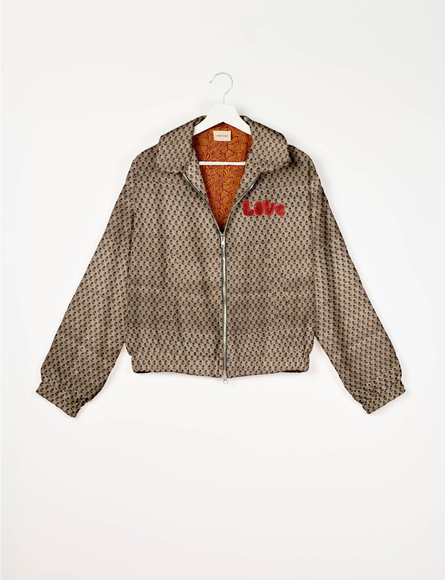 Love Bomber Jacket made from recycled fabric, featuring hand-stitched Aari embroidery. A unique piece of zero-waste clothing, part of the circular fashion movement. Designed with upcycled materials for a stylish yet environmentally friendly clothing choice.