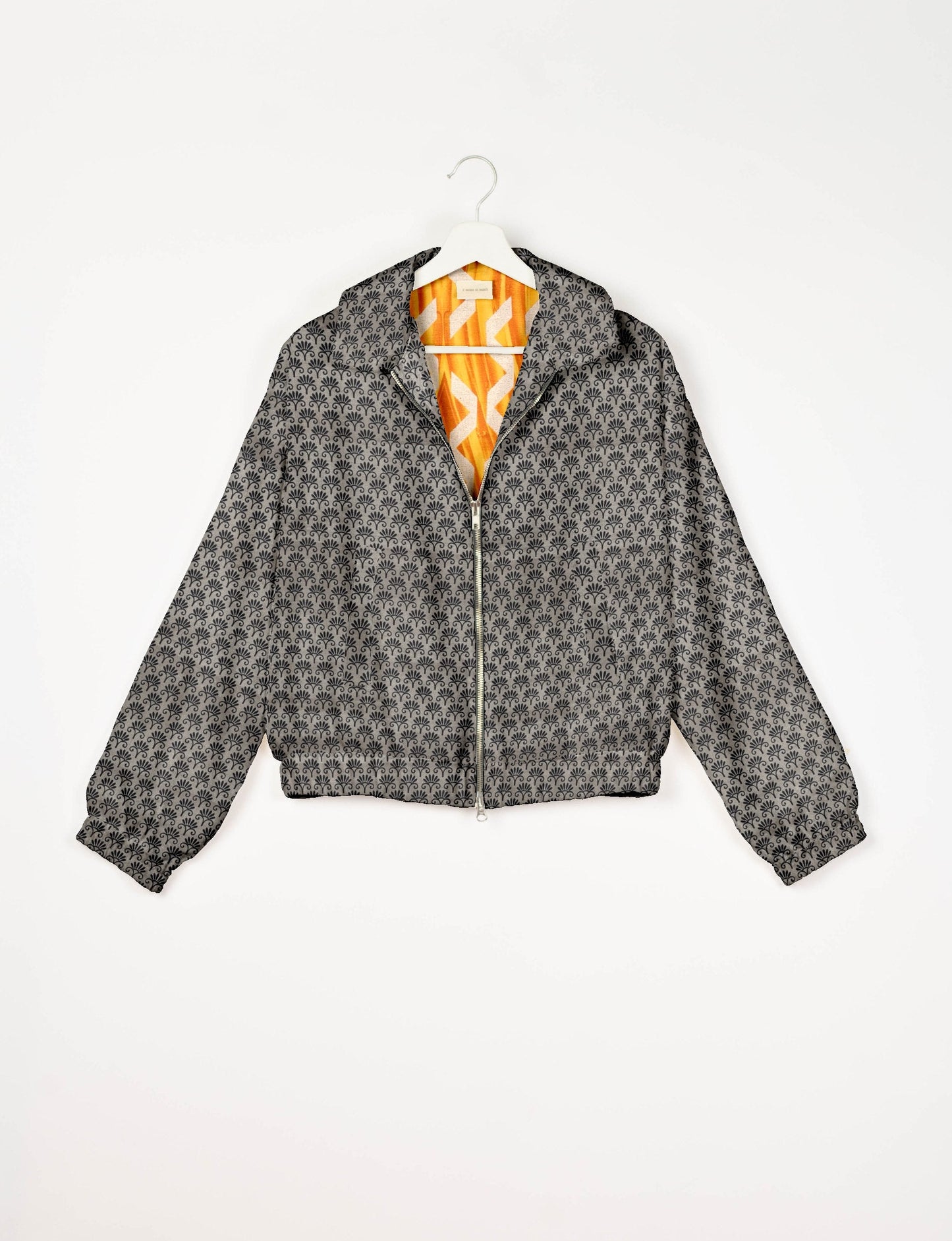 Stylish BOMBER JACKET, an upcycled clothing masterpiece with a cute cropped shape, elasticated details, and detachable metallic zipper. Contrast sari print lining adds a unique touch. Explore sustainable and eco-friendly fashion.