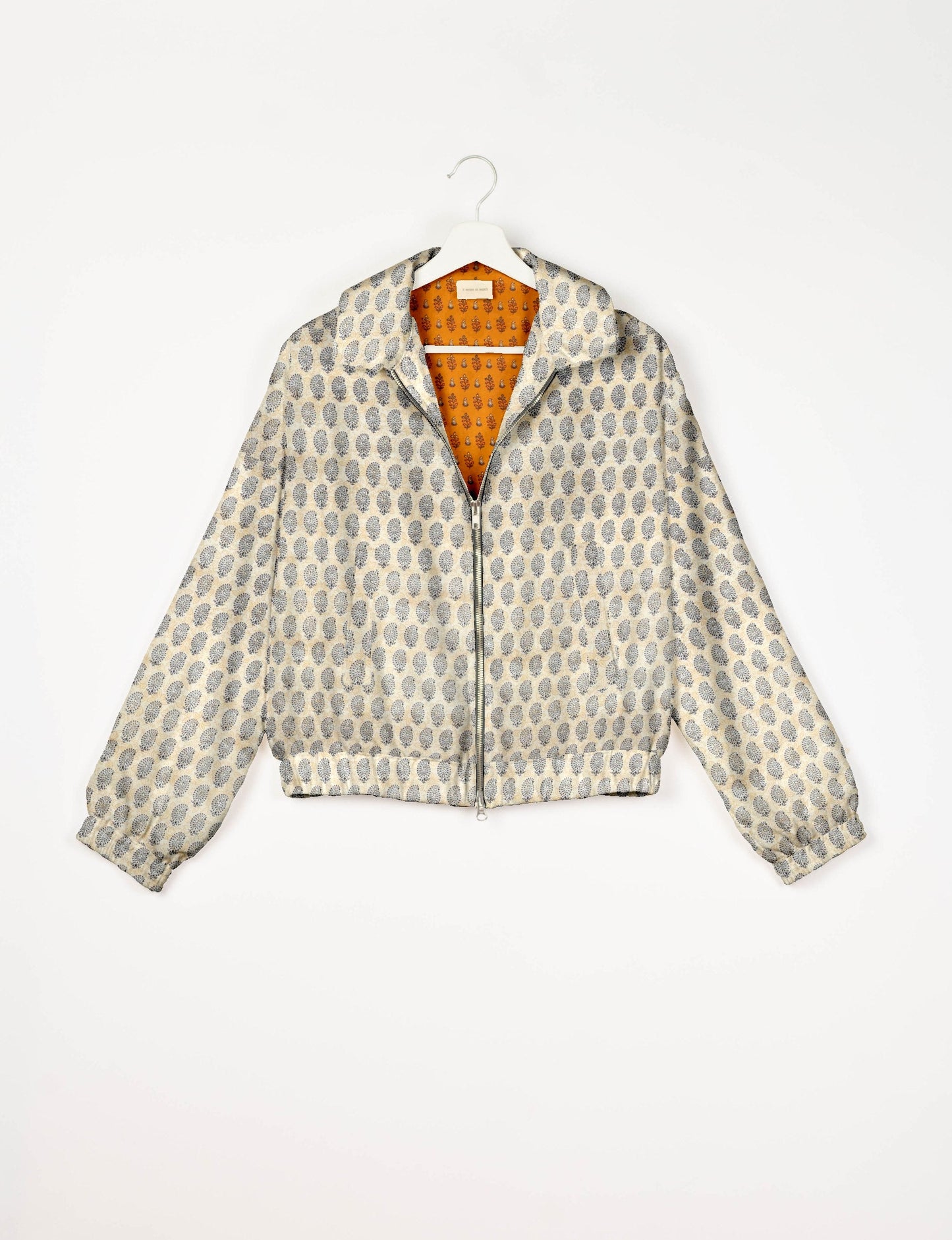 Stylish BOMBER JACKET, an upcycled clothing masterpiece with a cute cropped shape, elasticated details, and detachable metallic zipper. Contrast sari print lining adds a unique touch. Explore sustainable and eco-friendly fashion.