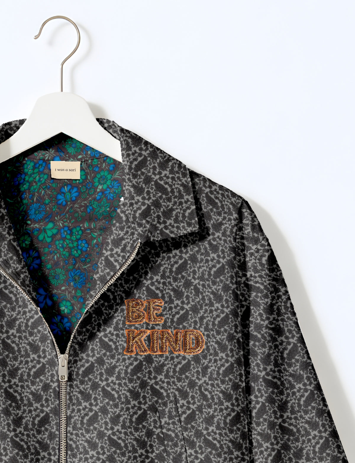 BE KIND Bomber jacket made from upcycled sari fabric with handcrafted Aari embroidery by female artisans.