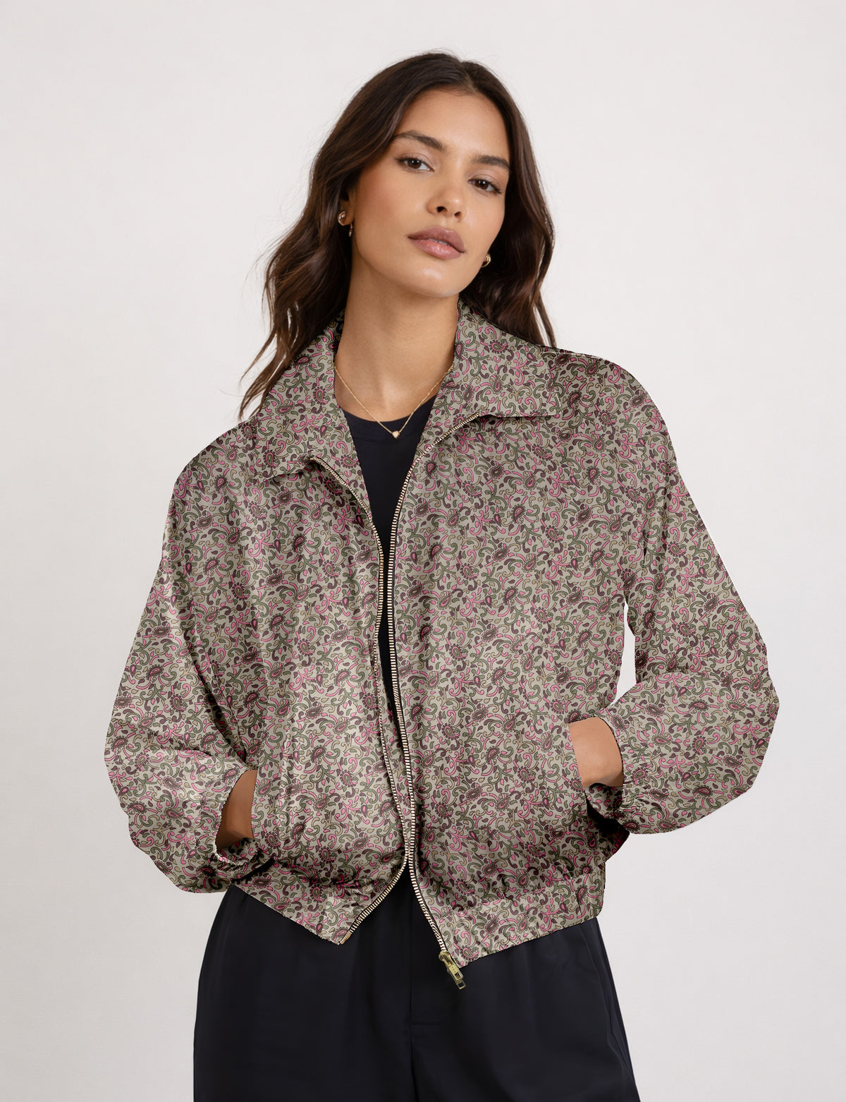 Woman wearing a yellow floral bomber jacket with front zipper, elastic cuffs, and side pockets, shown from front view