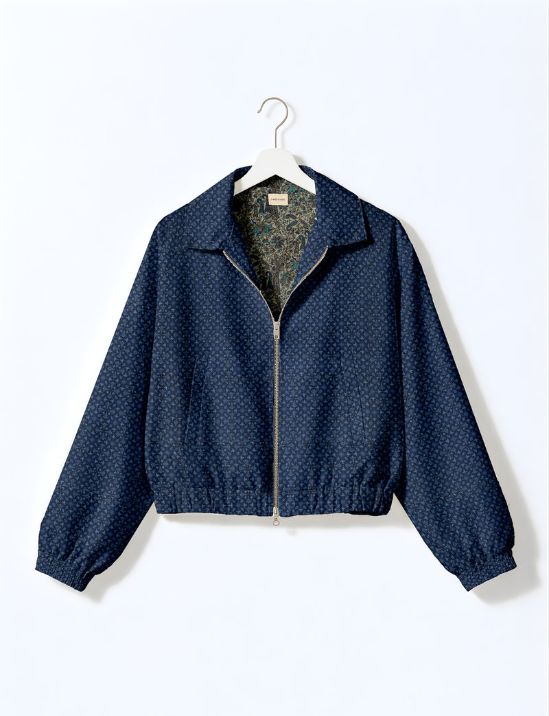 Brown floral bomber jacket with front zipper, elastic cuffs and hem, hanging on white hanger, red floral inner lining visible