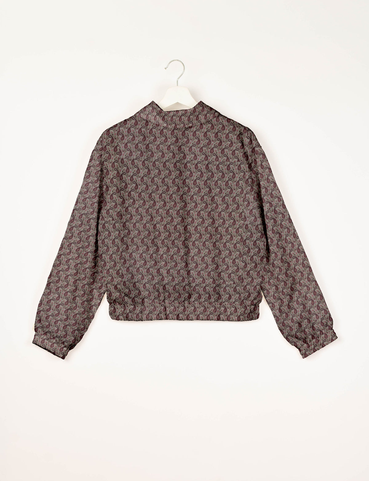 Beige bomber jacket with maroon paisley pattern, elastic cuffs and waistband, shown from back on white hanger