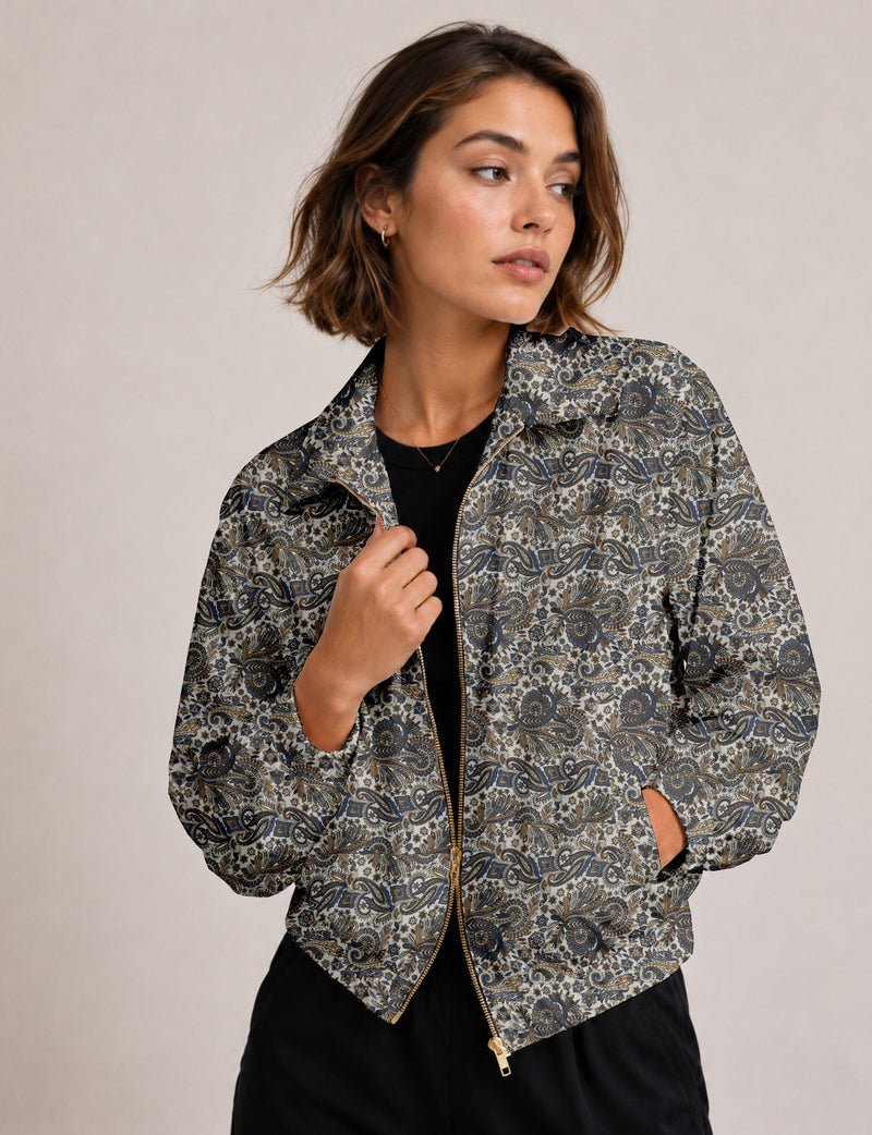 Brown floral bomber jacket with front zipper, elastic cuffs and hem, hanging on white hanger, red floral inner lining visible