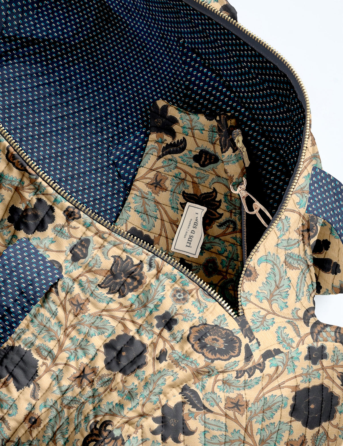 Brown paisley quilted bowling bag with dual handles, front zipper pocket, and "I was a sari" label on front side
