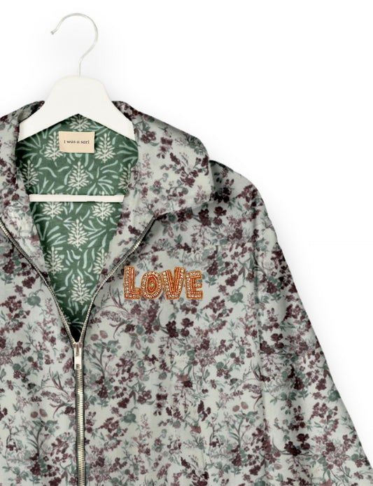 Love Bomber Jacket made from recycled fabric, featuring hand-stitched Aari embroidery. A unique piece of zero-waste clothing, part of the circular fashion movement. Designed with upcycled materials for a stylish yet environmentally friendly clothing choice.