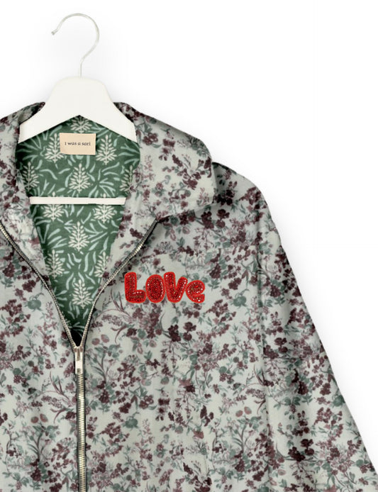 Love Bomber Jacket made from recycled fabric, featuring hand-stitched Aari embroidery. A unique piece of zero-waste clothing, part of the circular fashion movement. Designed with upcycled materials for a stylish yet environmentally friendly clothing choice.