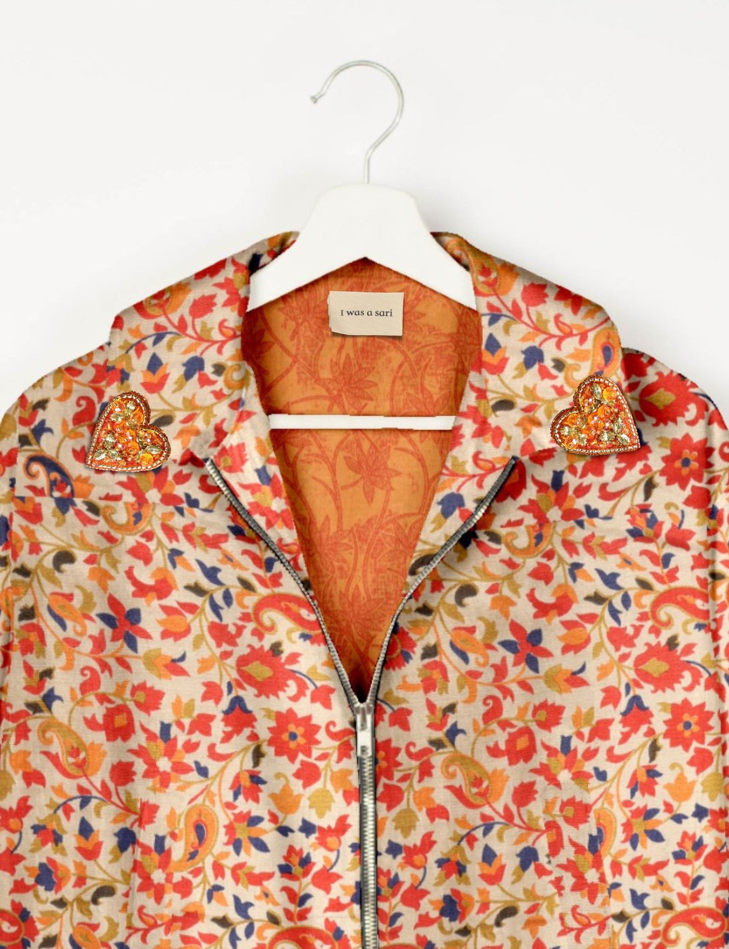 Make a bold statement with our Heart Drop Earrings, a symbol of conscious luxury and ethical fashion. Handcrafted using the intricate Aari embroidery technique, these earrings are made from upcycled sari fabric, embracing slow fashion and zero waste clothing. Elevate your look with sustainable apparel that supports fair trade fashion while reducing textile waste. Choose eco-friendly fashion that speaks of love, artistry, and responsibility.