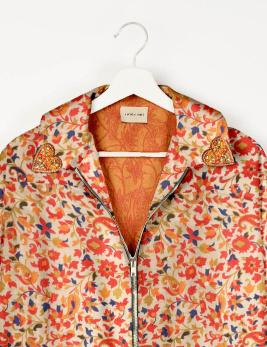 Make a bold statement with our Heart Drop Earrings, a symbol of conscious luxury and ethical fashion. Handcrafted using the intricate Aari embroidery technique, these earrings are made from upcycled sari fabric, embracing slow fashion and zero waste clothing. Elevate your look with sustainable apparel that supports fair trade fashion while reducing textile waste. Choose eco-friendly fashion that speaks of love, artistry, and responsibility.