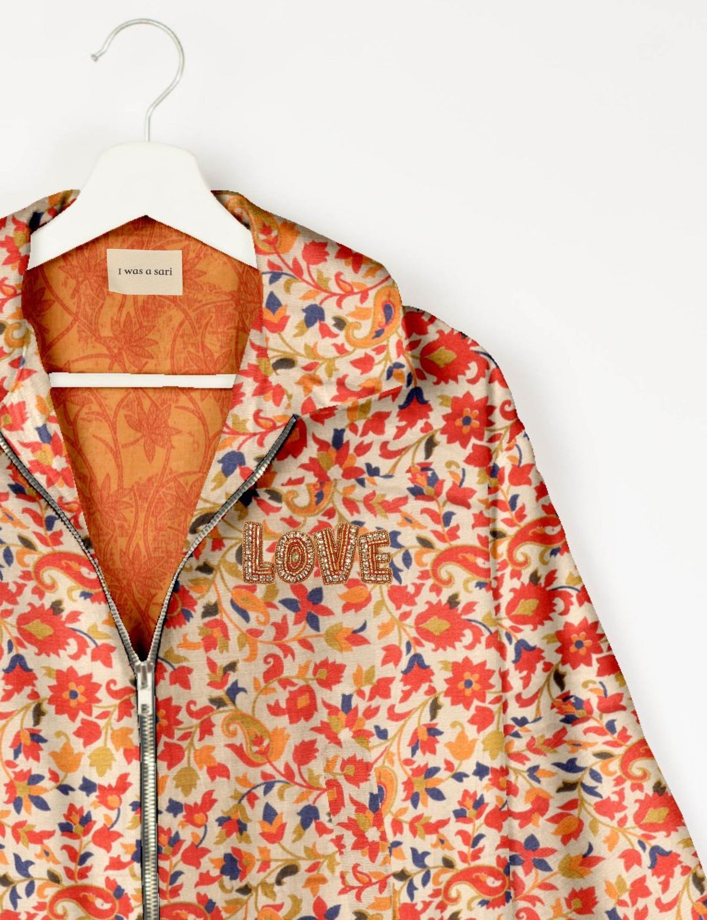 Love Bomber Jacket made from recycled fabric, featuring hand-stitched Aari embroidery. A unique piece of zero-waste clothing, part of the circular fashion movement. Designed with upcycled materials for a stylish yet environmentally friendly clothing choice.