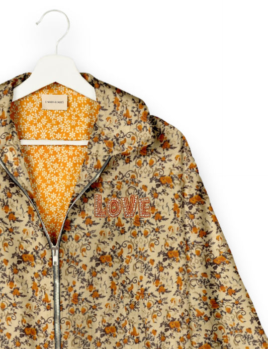 Love Bomber Jacket made from recycled fabric, featuring hand-stitched Aari embroidery. A unique piece of zero-waste clothing, part of the circular fashion movement. Designed with upcycled materials for a stylish yet environmentally friendly clothing choice.