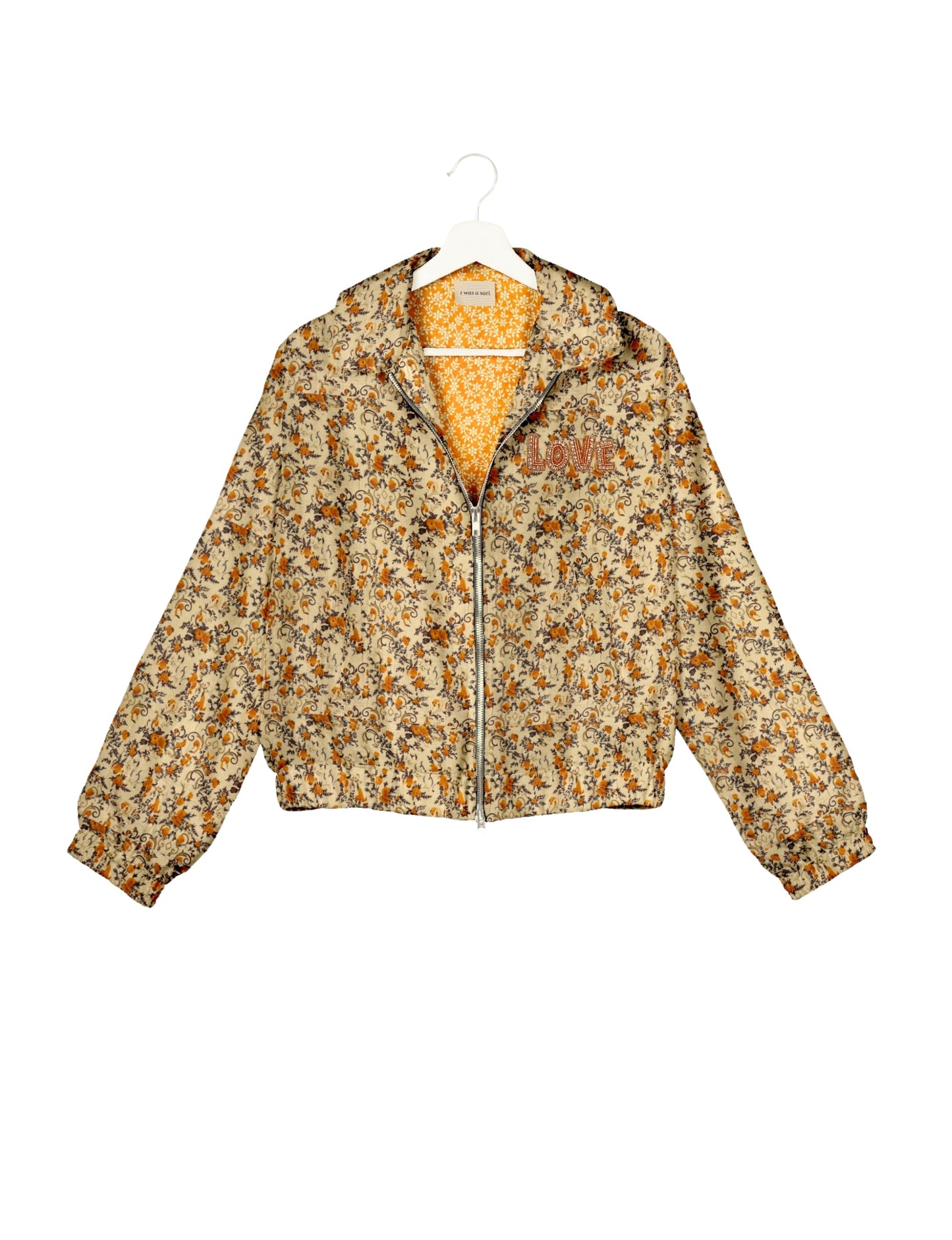 Love Bomber Jacket made from recycled fabric, featuring hand-stitched Aari embroidery. A unique piece of zero-waste clothing, part of the circular fashion movement. Designed with upcycled materials for a stylish yet environmentally friendly clothing choice.