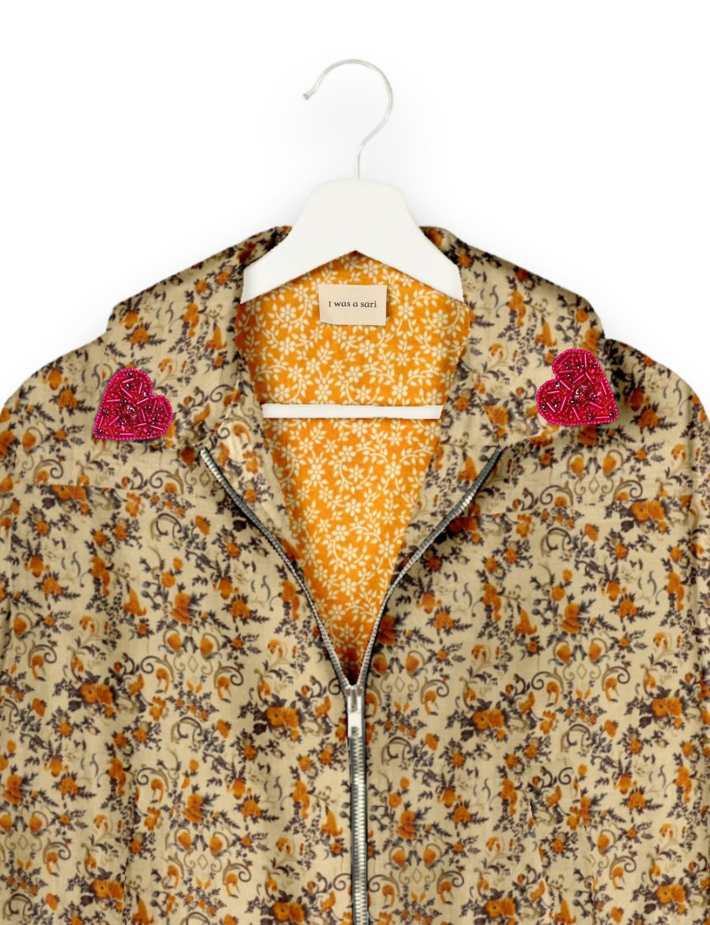 Make a bold statement with our Heart Drop Earrings, a symbol of conscious luxury and ethical fashion. Handcrafted using the intricate Aari embroidery technique, these earrings are made from upcycled sari fabric, embracing slow fashion and zero waste clothing. Elevate your look with sustainable apparel that supports fair trade fashion while reducing textile waste. Choose eco-friendly fashion that speaks of love, artistry, and responsibility.