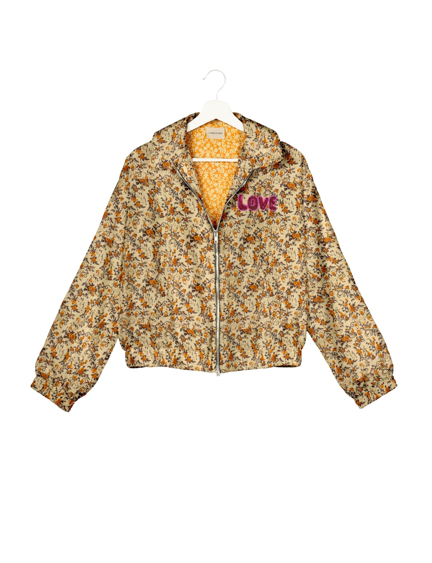 Love Bomber Jacket made from recycled fabric, featuring hand-stitched Aari embroidery. A unique piece of zero-waste clothing, part of the circular fashion movement. Designed with upcycled materials for a stylish yet environmentally friendly clothing choice.