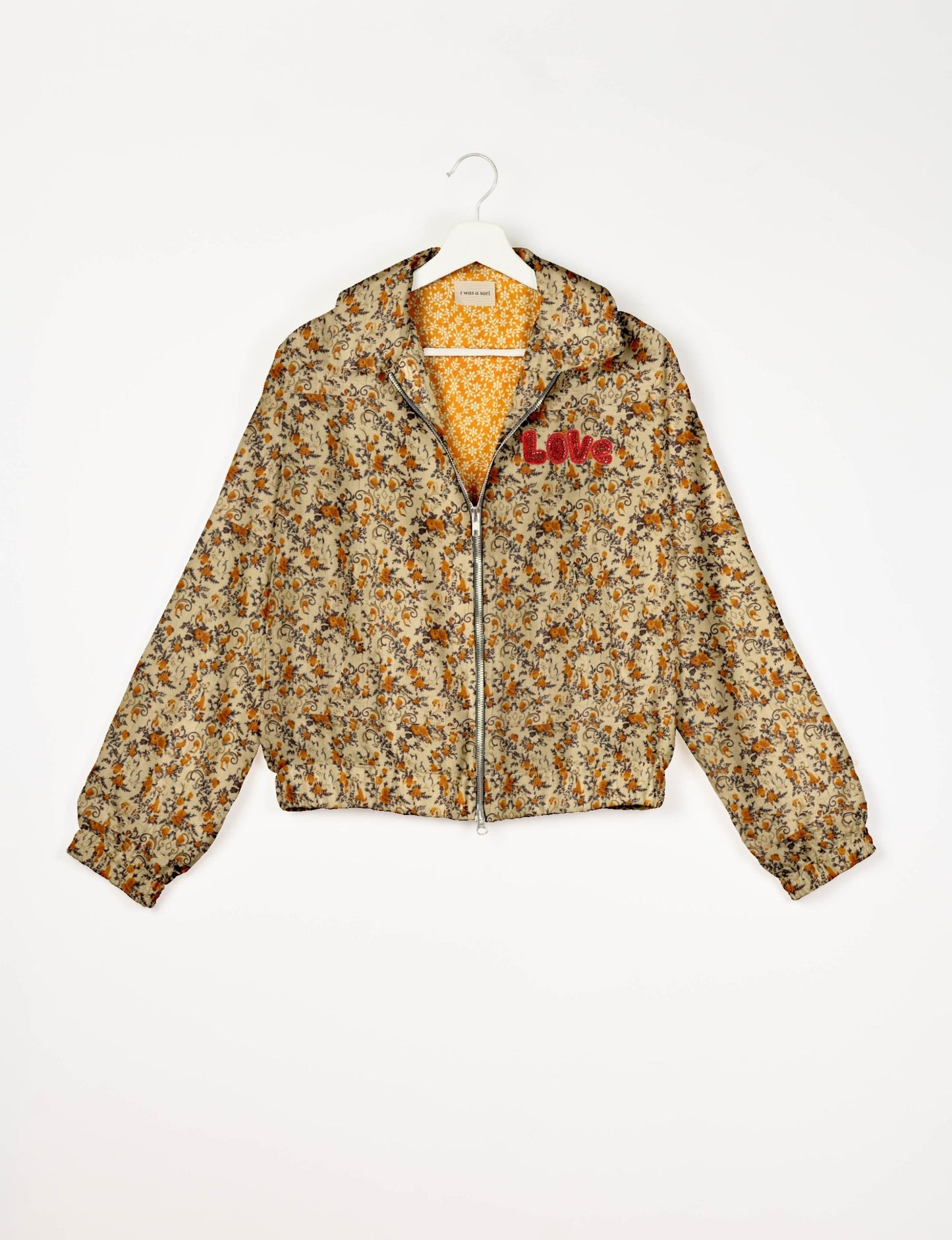 Love Bomber Jacket made from recycled fabric, featuring hand-stitched Aari embroidery. A unique piece of zero-waste clothing, part of the circular fashion movement. Designed with upcycled materials for a stylish yet environmentally friendly clothing choice.