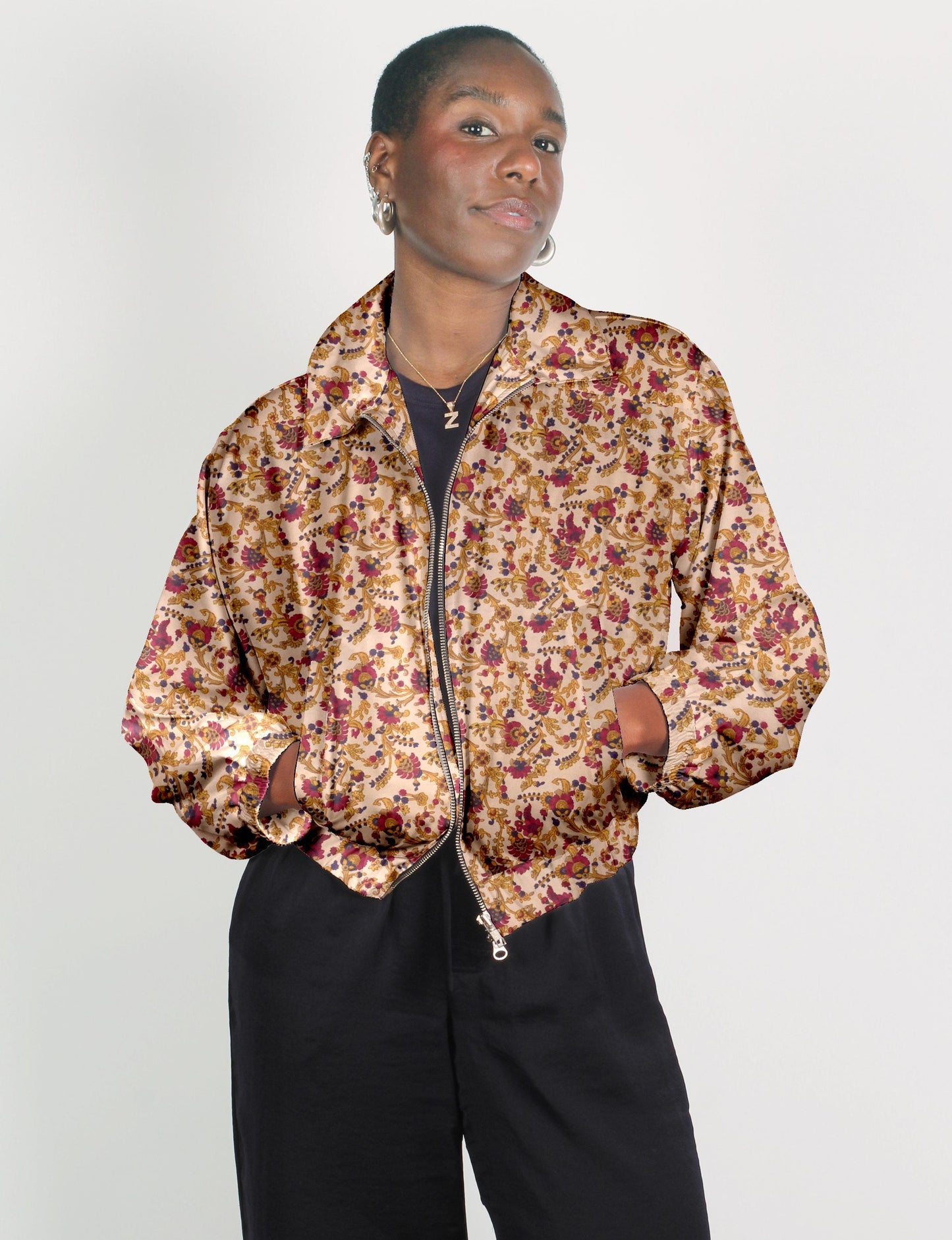 Stylish BOMBER JACKET, an upcycled clothing masterpiece with a cute cropped shape, elasticated details, and detachable metallic zipper. Contrast sari print lining adds a unique touch. Explore sustainable and eco-friendly fashion.