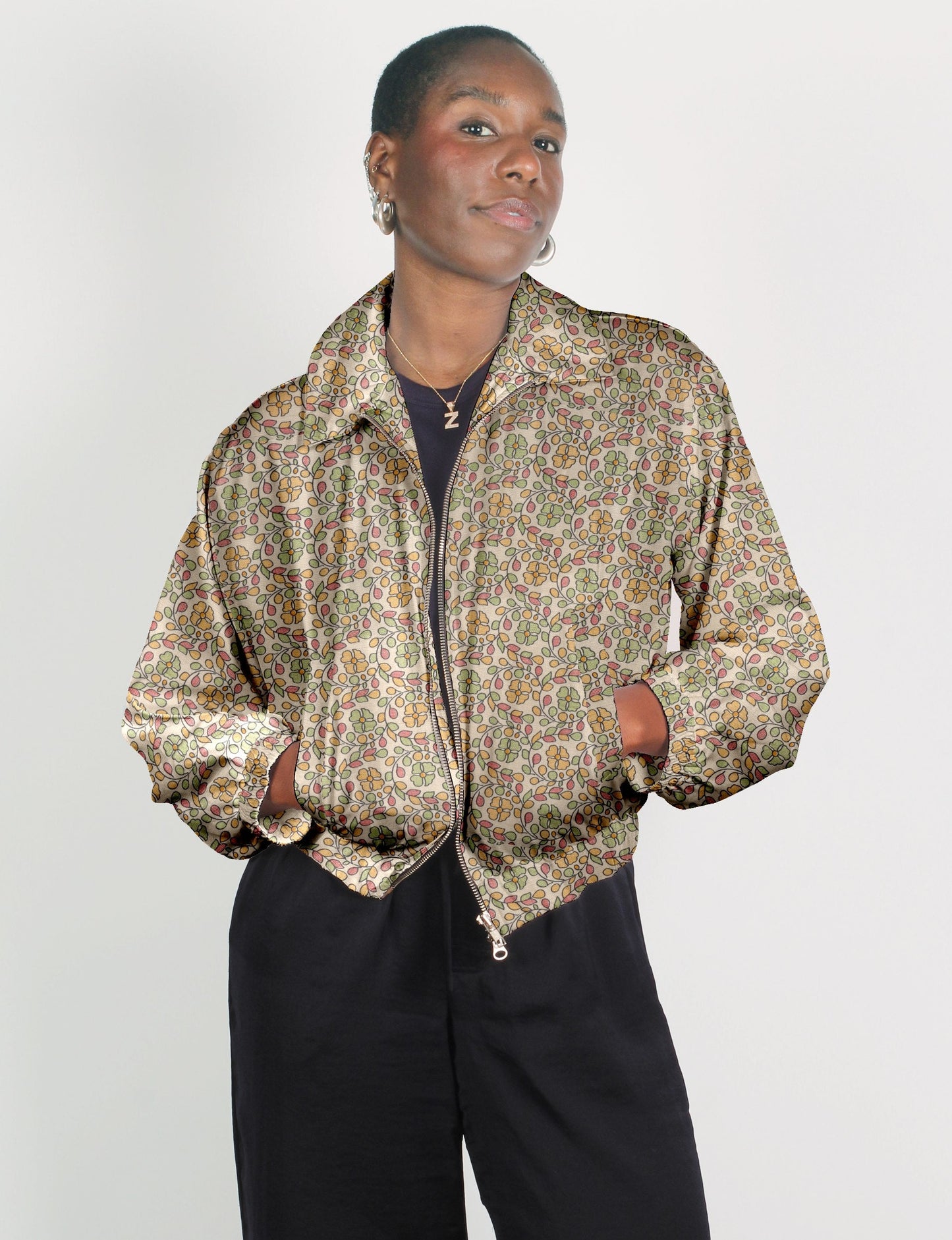 Upcycled Bomber Jacket made from recycled sari materials, featuring a cute cropped shape, elasticated hem and cuffs, and contrast sari print lining. Sustainable apparel promoting eco-friendly fashion and ethical clothing.