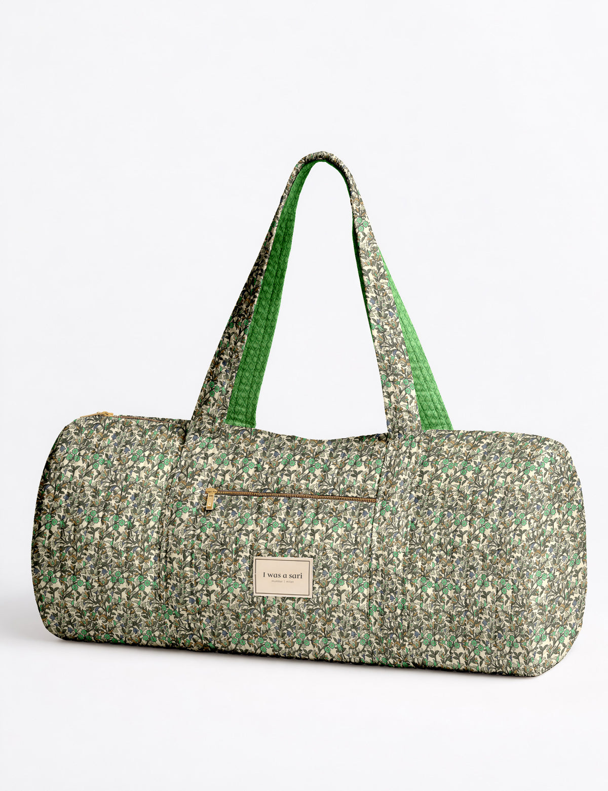 Brown paisley quilted bowling bag with front zipper pocket, held by person wearing white shirt and light blue jeans