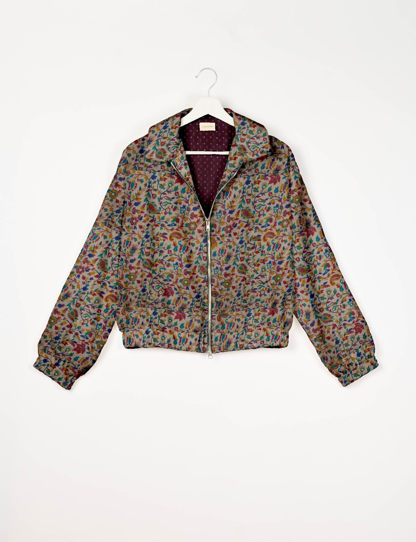 Upcycled Bomber Jacket made from recycled sari materials, featuring a cute cropped shape, elasticated hem and cuffs, and contrast sari print lining. Sustainable apparel promoting eco-friendly fashion and ethical clothing.