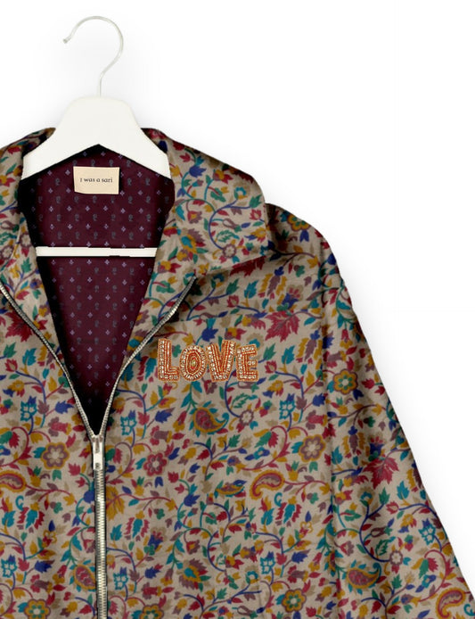 Love Bomber Jacket made from recycled fabric, featuring hand-stitched Aari embroidery. A unique piece of zero-waste clothing, part of the circular fashion movement. Designed with upcycled materials for a stylish yet environmentally friendly clothing choice.
