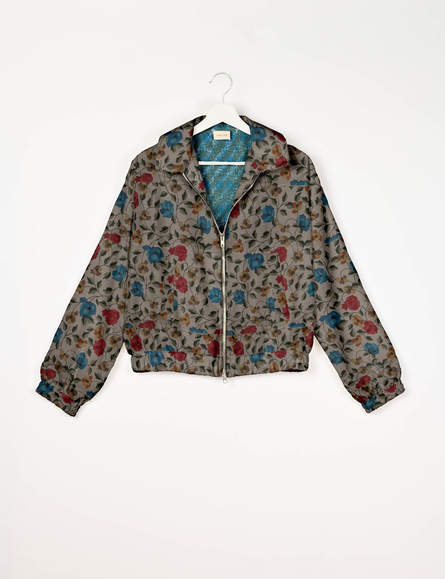 Upcycled Bomber Jacket made from recycled sari materials, featuring a cute cropped shape, elasticated hem and cuffs, and contrast sari print lining. Sustainable apparel promoting eco-friendly fashion and ethical clothing.