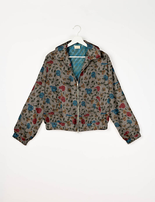 Upcycled Bomber Jacket made from recycled sari materials, featuring a cute cropped shape, elasticated hem and cuffs, and contrast sari print lining. Sustainable apparel promoting eco-friendly fashion and ethical clothing.