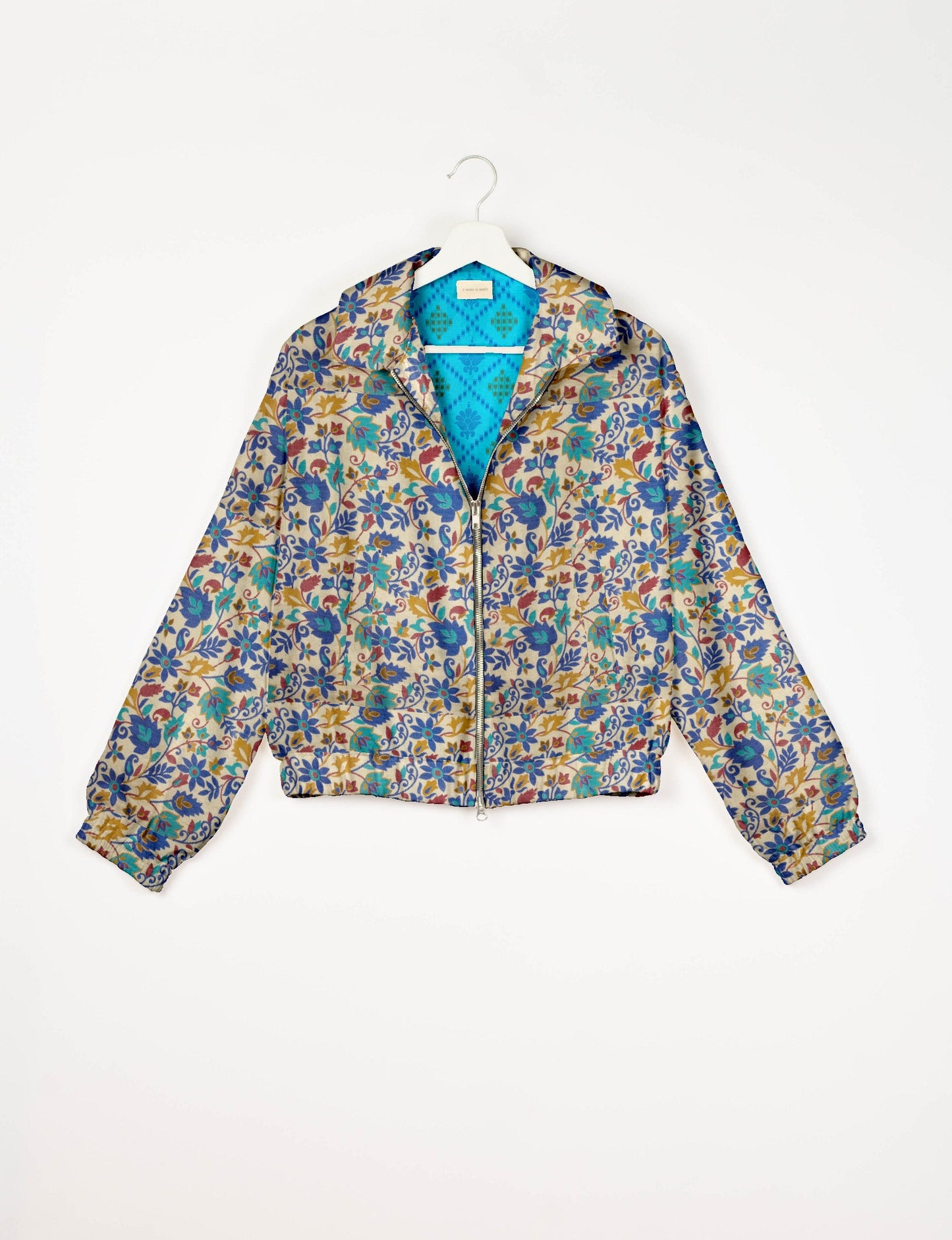 Upcycled Bomber Jacket made from recycled sari materials, featuring a cute cropped shape, elasticated hem and cuffs, and contrast sari print lining. Sustainable apparel promoting eco-friendly fashion and ethical clothing.