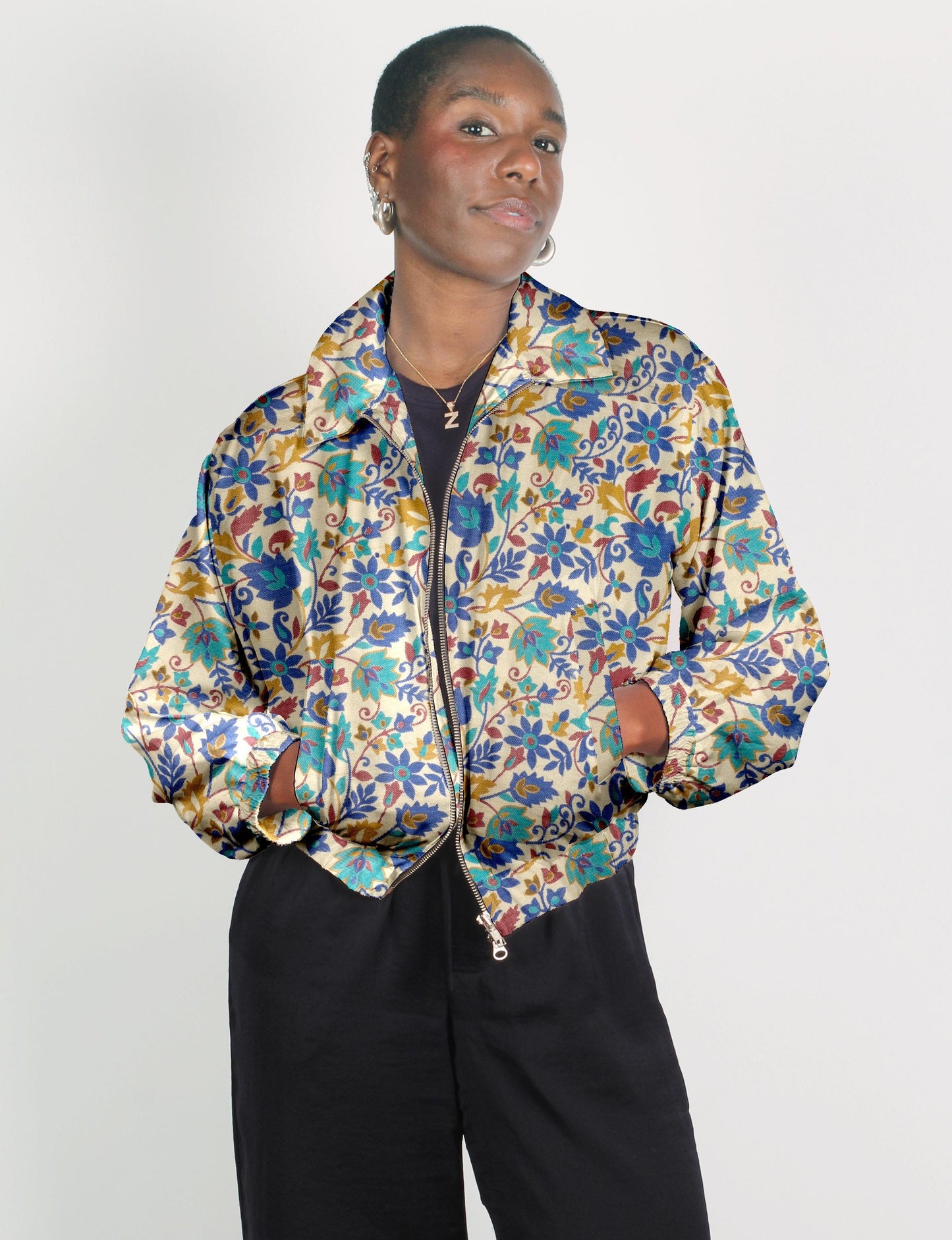 Upcycled Bomber Jacket made from recycled sari materials, featuring a cute cropped shape, elasticated hem and cuffs, and contrast sari print lining. Sustainable apparel promoting eco-friendly fashion and ethical clothing.